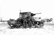 Asisbiz Army German soldiers pose for a photo against a knocked out Polish 7TR tank 01