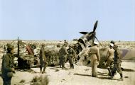 Asisbiz German and Italian troops inspect a burnt out Hurricane wreck Western Desert 01