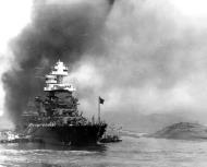 Asisbiz USS Maryland (BB 46) at berth F 5 with men working on the capsized hull of USS Oklahoma Pearl Harbor 7th Dec 1941 NH 83065