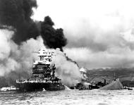 Asisbiz USS Maryland (BB 46) with the capsized USS Oklahoma (BB 37) and USS West Virginia (BB 48) burning at Pearl Harbor 7th Dec 1941 80 G 19949