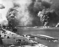 Asisbiz USS Shaw (DD 373) in floating drydock YFD 2 and USS Nevada (BB 36) burning at right Pearl Harbor 7th Dec 1941 80 G 474789