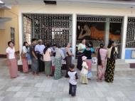 Asisbiz Meilamu Pagoda donating gold leaf Yangon Myanmar 02