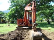 Asisbiz Using a Hitachi Backhoe to remove coco tree stumps Tabinay Philippines 01