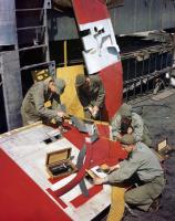 Asisbiz B 24 Liberator 8AF 466BG sheet metal workers mend a flak damaged rudder England 1944 01