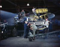Asisbiz Lockheed P 38 Lightning undergoing engine replacement by Air Force Mechanics in a hangar USA