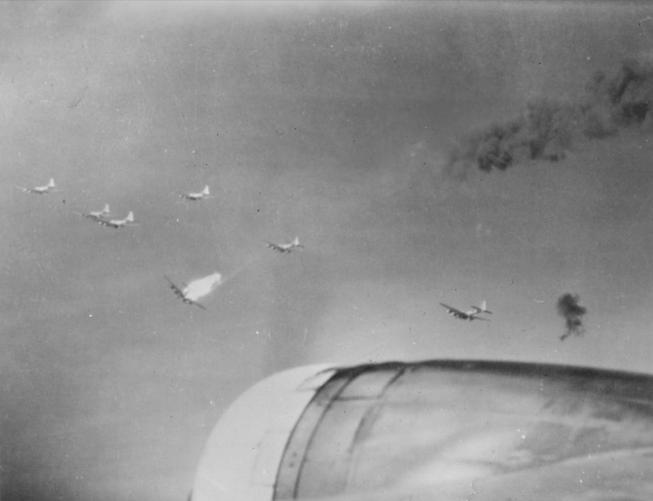 Asisbiz Boeing B-17G Fortress with a burning fuel falls away from its ...