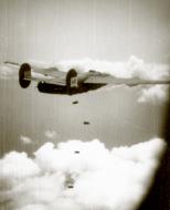 Asisbiz 42 100410 B 24J Liberator 5AF 22BG19BS dropping bombs over a target in New Guinea 01