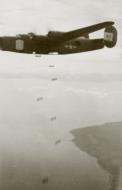 Asisbiz 42 100410 B 24J Liberator 5AF 22BG19BS dropping bombs over a target in New Guinea 02