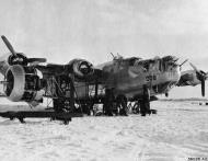 Asisbiz Consolidated B 24 Liberator 8AF ground crews replacing a engine on 008 winter 1944 45 01