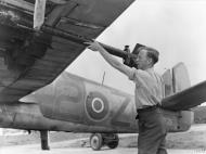 Asisbiz Beaufighter TFX RCAF 404Sqn 2Z LZ295 being fitted with 3 inch 25lb rockets at Davidstow Moore Cornwall IWM MH7466