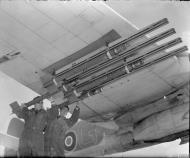 Asisbiz Beaufighter X RCAF 404Sqn 2G being fitted with 3 inch 25lb rockets at Davidstow Moor Cornwall IWM CH13179