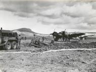 Asisbiz A RAF Beaufighter MkVIF Red C sit ideally by as a bulldozer files a bomb crator 01