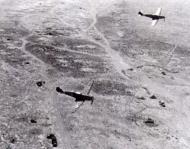 Asisbiz Messerschmitt Bf 109E7Trop 1.JG27 White 7 and 1 on low level patrol over Libya Feb 1942 02