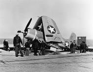 Asisbiz Vought F4U 1 Corsair VF 17 Jolly Rogers on the deck of CVE 30 USS Charger 01