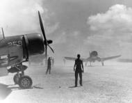 Asisbiz Vought F4U 1D Corsair take off in a dust storm armed with 500lb bombs on Majuro Atoll Marshall Islands Aug 1944 80 G 425525