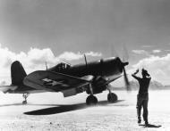 Asisbiz Vought F4U 1D Corsair take off in a dust storm armed with 500lb bombs on Majuro Atoll Marshall Islands Aug 1944 80 G 425526