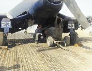 Asisbiz Vought F4U 4B Corsair VMF 214 Black Sheep WE23 being fitted with napalm by TSgt FC Jewett and Sgt JM Jackson 8th Oct 1951 Pohang Korea 01