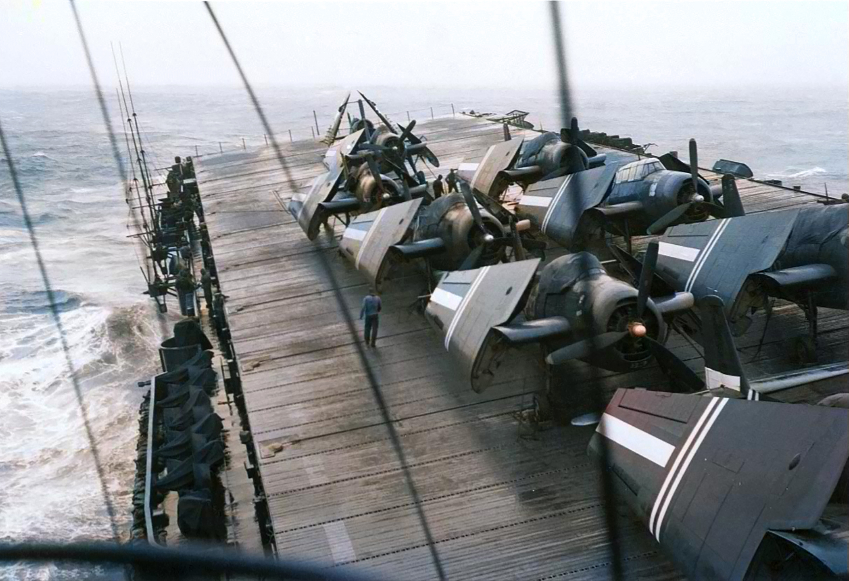 USS Gilbert Islands CVE-107 flight with Grumman TBF Avengers tied down in rough seas typhoon 1945