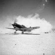 Asisbiz Curtiss Tomahawk MkIIB RAF 250Sqn raises the dust at LG 13 or Sidi Heneish South before taking off on a patrol IWM CM1001