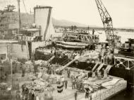 Asisbiz Reinforcing Crete scene on the quayside as the warship was disembarking men and material IWM E1159