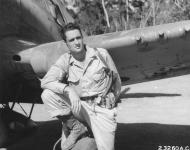 Asisbiz American USAAF 49FG pilot Robert A McDaris beside his Curtiss P 40 Warhawk in New Guinea NA1101