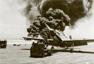 Asisbiz P 51D Mustang 7AF 21FG46FS 226 The Gator being moved away from the burning B 29 Superfortress at Iwo Jima 1945 01
