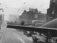 Asisbiz Newly shipped P 51 Mustangs are moved from the Liverpool docks to a assembly field England 1944 01