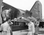 Asisbiz 44 76662 Douglas C 47A Skytrain unloading a allied POW from Rangoon Burma still too weak to stand 1945 NA411