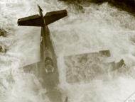 Asisbiz Fleet Air Arm Martlet pilot tries to free himself after take off accident HMS Searcher IWM A27331