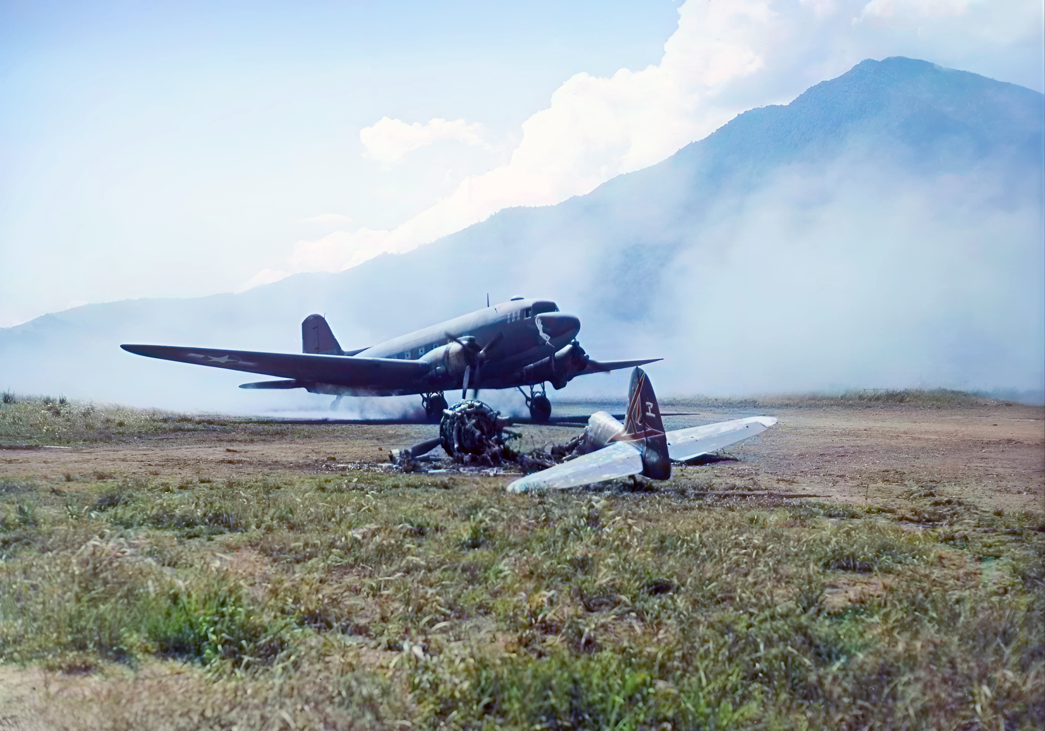 Douglas C 47 Dakota 111 passes a destroyed Japanese Ki-43 II Oscar 63rd Sentai Cyclops Hollandia 28th Apr 1944