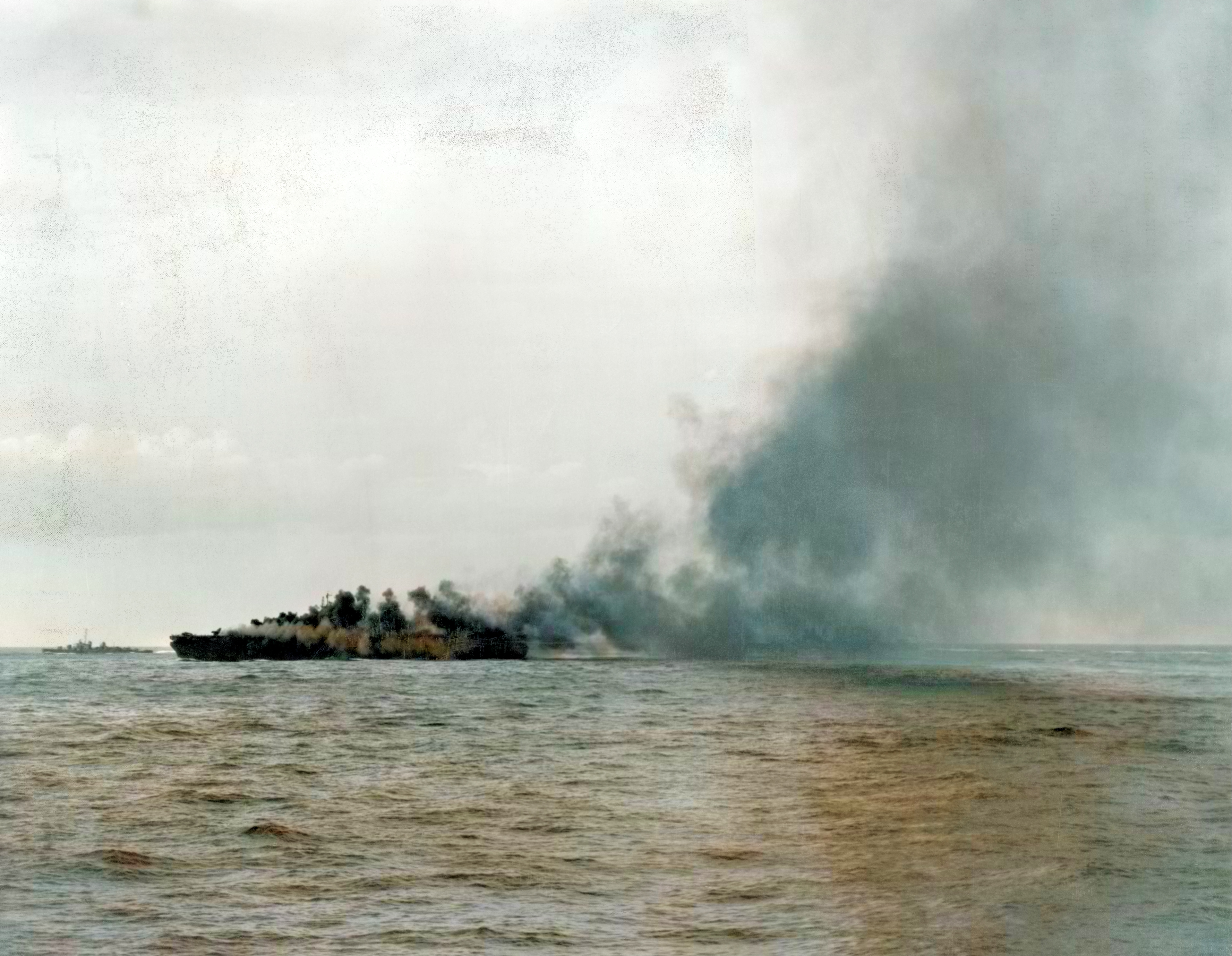 USS Enterprise (CV 6) burning after a kamikaze attack during the battle of Okinawa 14th May 1945