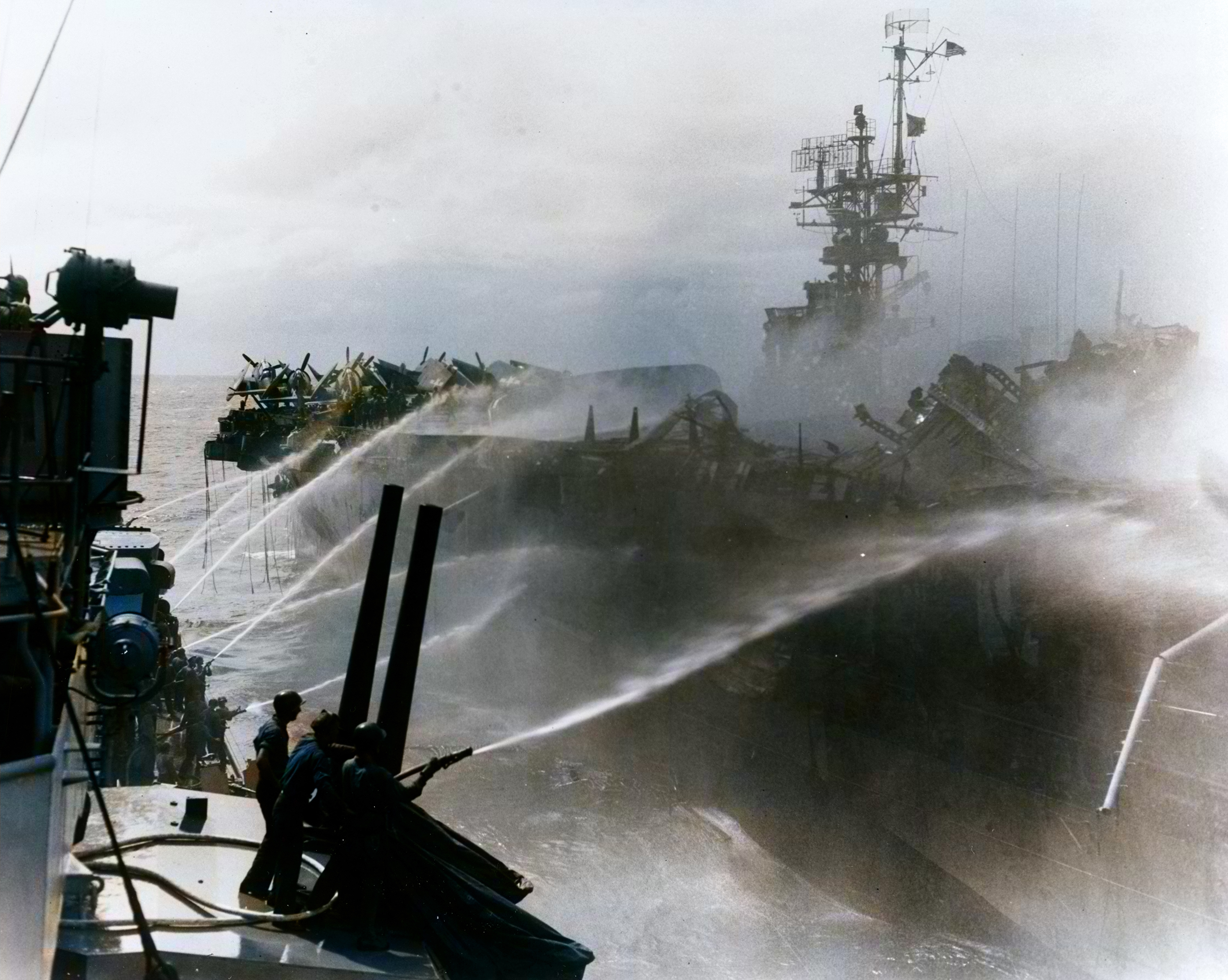 Asisbiz USS Princeton (CVL 23) seen from USS Birmingham (CL 62) during attempts to control her fires 24th Oct 1944 80 G 270357